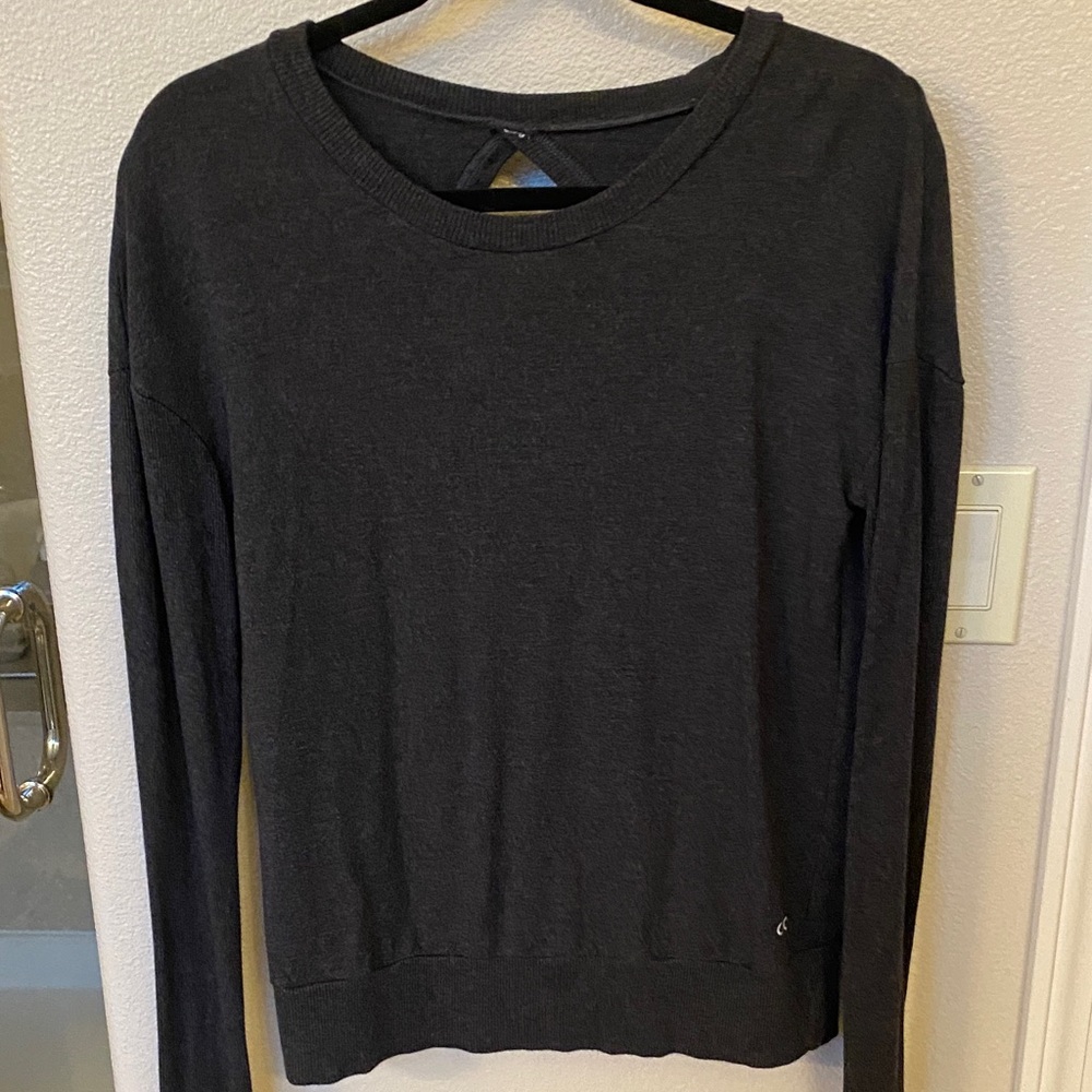 Alo dark grey sweatshirt with open back design.